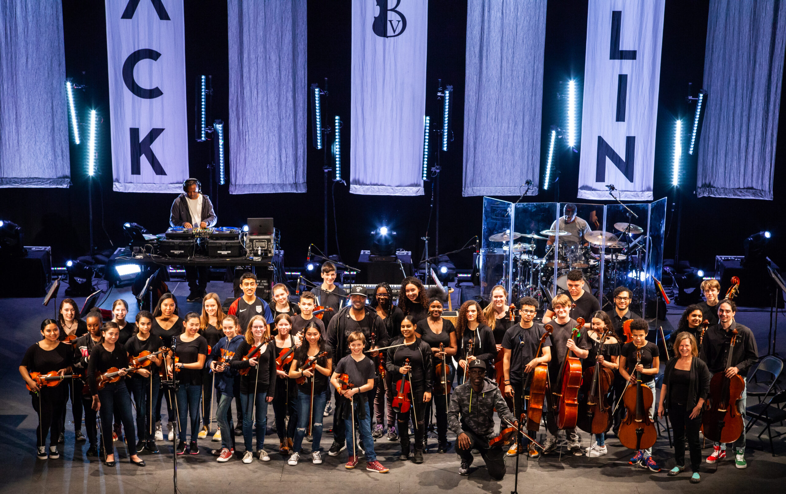 Students onstage after performing with Black Violin at The VETS in April 2019.