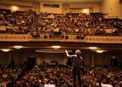 Vocalist Bobby McFerrin performs onstage for an audience.