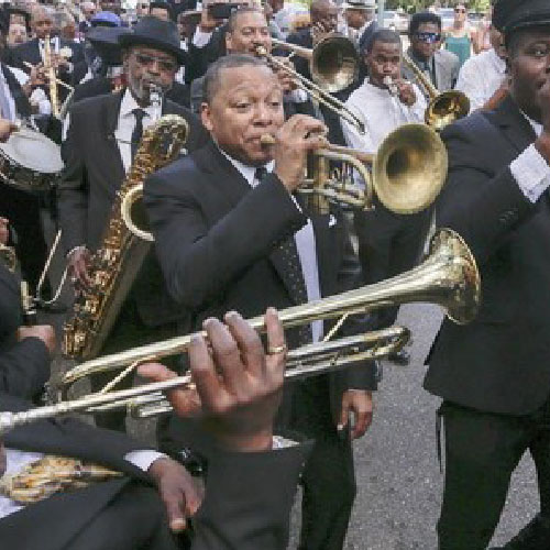 A second line band performing in the streets