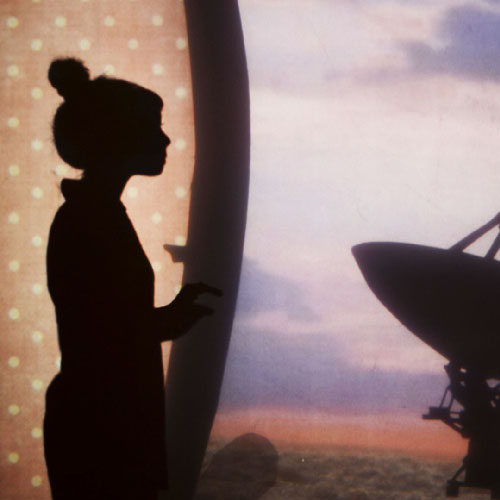 A shadow theater scene of a woman with a high bun gazing out at a field of satellite dishes