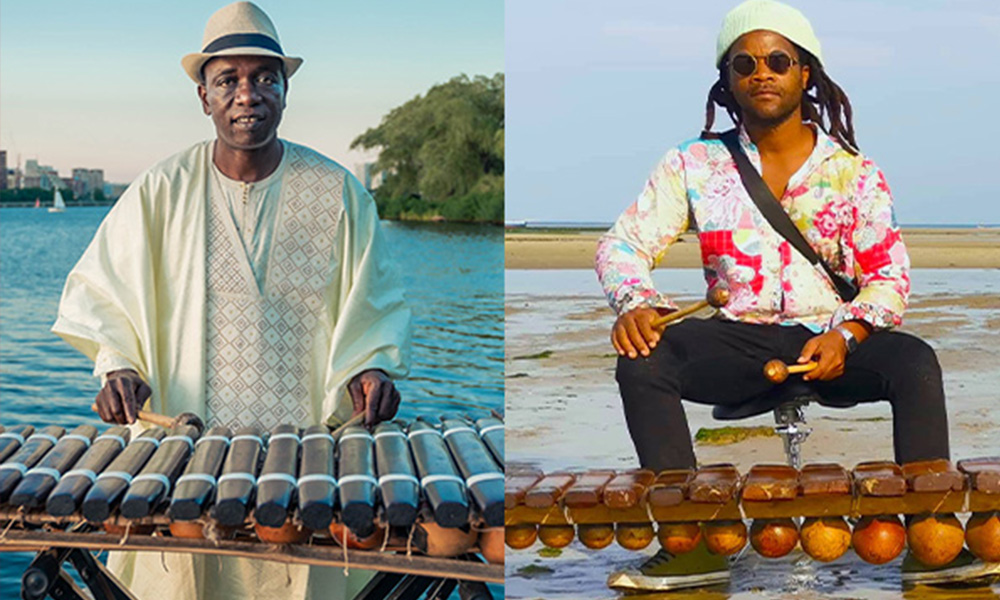 On the left side is a Black musician wearing a white robe and white hat with a black band playing the ballaphone outdoors near a body of water. On the right side is a Black musician with long twists and a brightly patterned long sleeve shirt sitting in front of a ballaphone on a beach